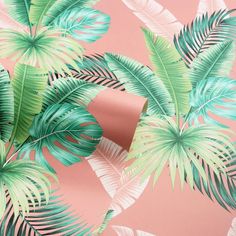 a pink wall with green palm leaves on it