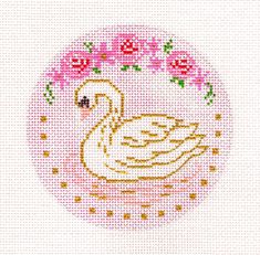 a cross stitch swan with roses in the background