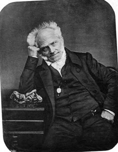 an old black and white photo of a man in a suit with his hand on his head