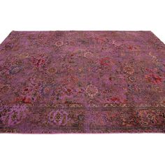 an antique persian rug with purple and red colors