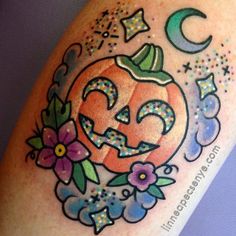 a tattoo with a pumpkin and stars on it