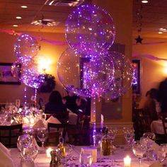 the table is set with balloons and place settings for guests to sit down at it