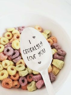 a white bowl filled with cereal and a spoon that says i cereally love you