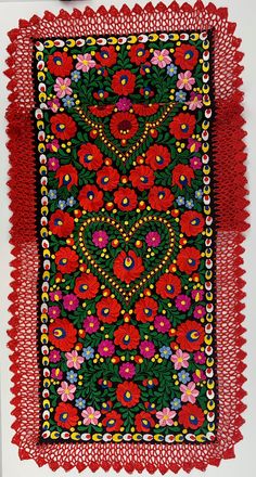 a red and green cloth with flowers on it