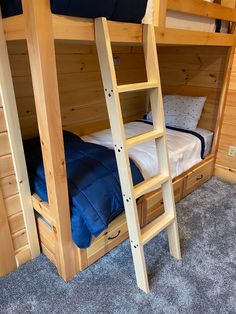 a bunk bed with two sets of ladders on the bottom and one set of mattresses on the top