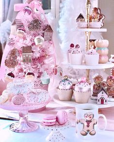 there is a pink tree with cupcakes on it and other decorations in the background