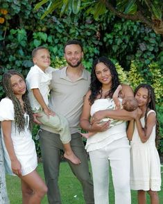 a man and two women are holding their children