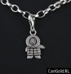 a silver chain with a small charm on it's end and an image of a person holding a baby in the middle