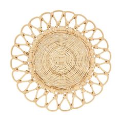 a round wicker tray with an intricate design in the center, on a white background