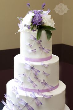 a wedding cake with purple and white decorations