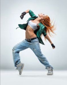 a woman dancing in the air with her hair blowing back and legs spread out,