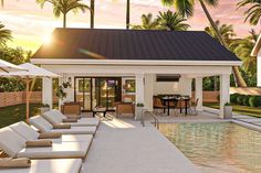 an outdoor pool area with lounge chairs and umbrellas next to the swimming pool at sunset