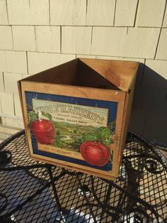 a wooden crate sitting on top of a metal table