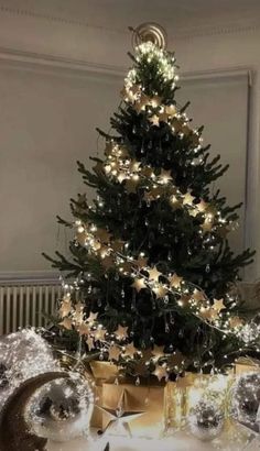 a christmas tree with lights and presents under it