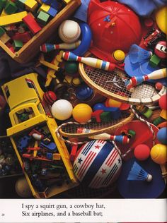 a pile of assorted toys including tennis rackets and balls