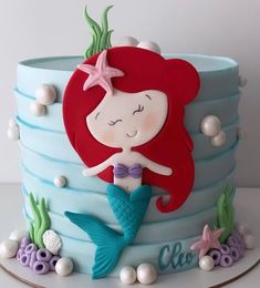 there is a cake with a little mermaid on it