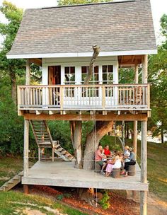 people sitting on the porch of a tree house