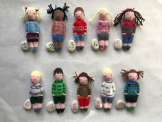 a group of knitted dolls sitting next to each other