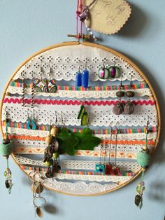 a wall hanging made out of different types of thread and beads