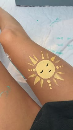 a woman's legs with sun and stars painted on them