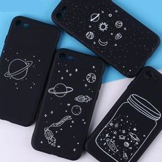 three phone cases with drawings on them sitting next to each other and one is black