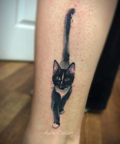 a black and white cat tattoo on the right leg, it looks like an ink painting