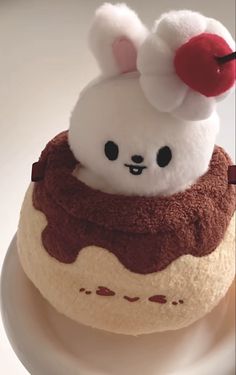 a small stuffed animal is sitting on top of a cupcake