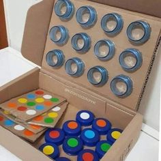 an open box filled with lots of different colored buttons