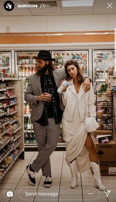 a man and woman walking through a grocery store