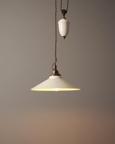 a white light hanging from a ceiling with two lights on each side and a cord attached to it