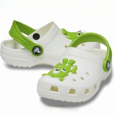 Design: Adorable Alien Design Glow In The Dark Iconic Crocs Comfort With Original Croslite Foam Cushion Heel Strap Keeps Shoe On Foot And Can Be Rolled Forward For A Slip-On Silhouette Anti-Microbial And Odor-Resistant Properties Toe Box Ventilation System For Cooling Comfort Footbed Supports And Comforts Their Feet All Day Long Built-In Arch Support Non-Marking Outsoles Additional Details: Easy To Clean And Quick To Dry; Washes Off With Soap And Water Customizable With Jibbitz Charms Cute White Clogs With Round Toe, Cute White Slip-on Clogs, Playful White Clogs, White Non-slip Clogs For Playtime, Non-slip White Clogs For Playtime, White Non-slip Round Toe Clogs, Fun White Slip-on Clogs, Playful White Non-slip Clogs, White Non-slip Fun Clogs