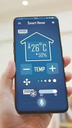 a person holding up a smart phone displaying the temperature