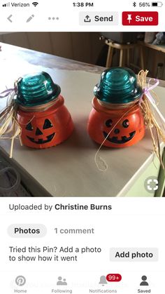 two pumpkin jars with faces on them sitting next to each other