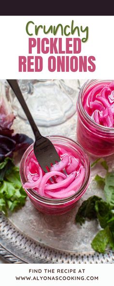 two jars filled with pickled red onions on top of a silver tray next to lettuce