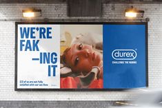 an advertisement for durex is displayed on the wall in front of a subway station