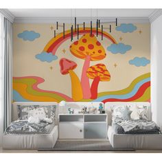 two beds sitting next to each other in front of a wall mural on the wall