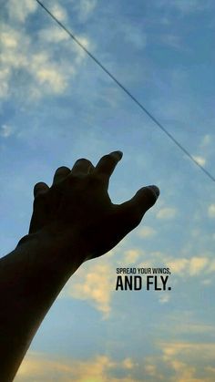 a hand reaching up into the sky to catch a kite in the air with an inspirational quote above it