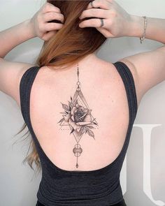 a woman with a rose tattoo on her back