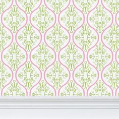 a white frame with a pink and green wallpaper