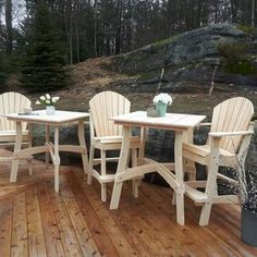 four chairs and a table on a wooden deck