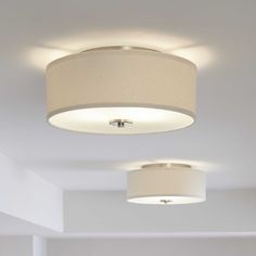 the ceiling light fixture in this living room is dimmed by white linen lampshades