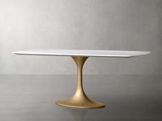 an oval white table with gold legs and a marble top, on a grey background