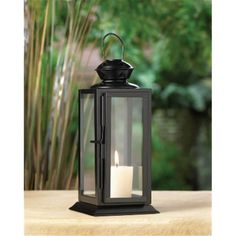 This rectangular candle lantern features a dark metal frame and clear glass panels that allow a candle of your choice to shine brightly. The top of the lantern features a starry cutout pattern and a hanging loop. Features . Made of Iron and glass.. Color - Black.. Dimension - 3.62 x 3.62 x 8 in.. Item Weight - 0.8 lbs. Hanging Candle Lanterns, Porthole Mirror, Dark Metal, Hanging Candles, Star Candle, Candle Lantern, Lantern Lamp, Metal Lanterns, Designer Candles