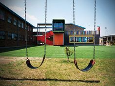 a swing set in front of a building