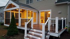 a porch with stairs and lights on it