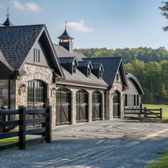 a large stone building with a black fence