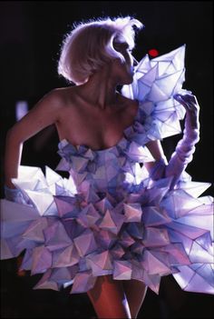 a woman in a dress made out of origami