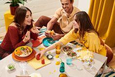 a group of people sitting around a table eating food