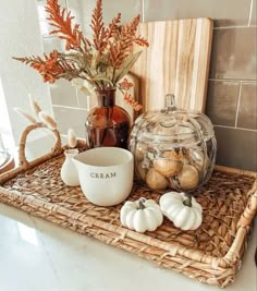 a basket with some pumpkins and other items on it