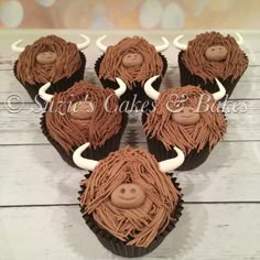 cupcakes decorated with chocolate frosting and brown icing are arranged in the shape of bulls